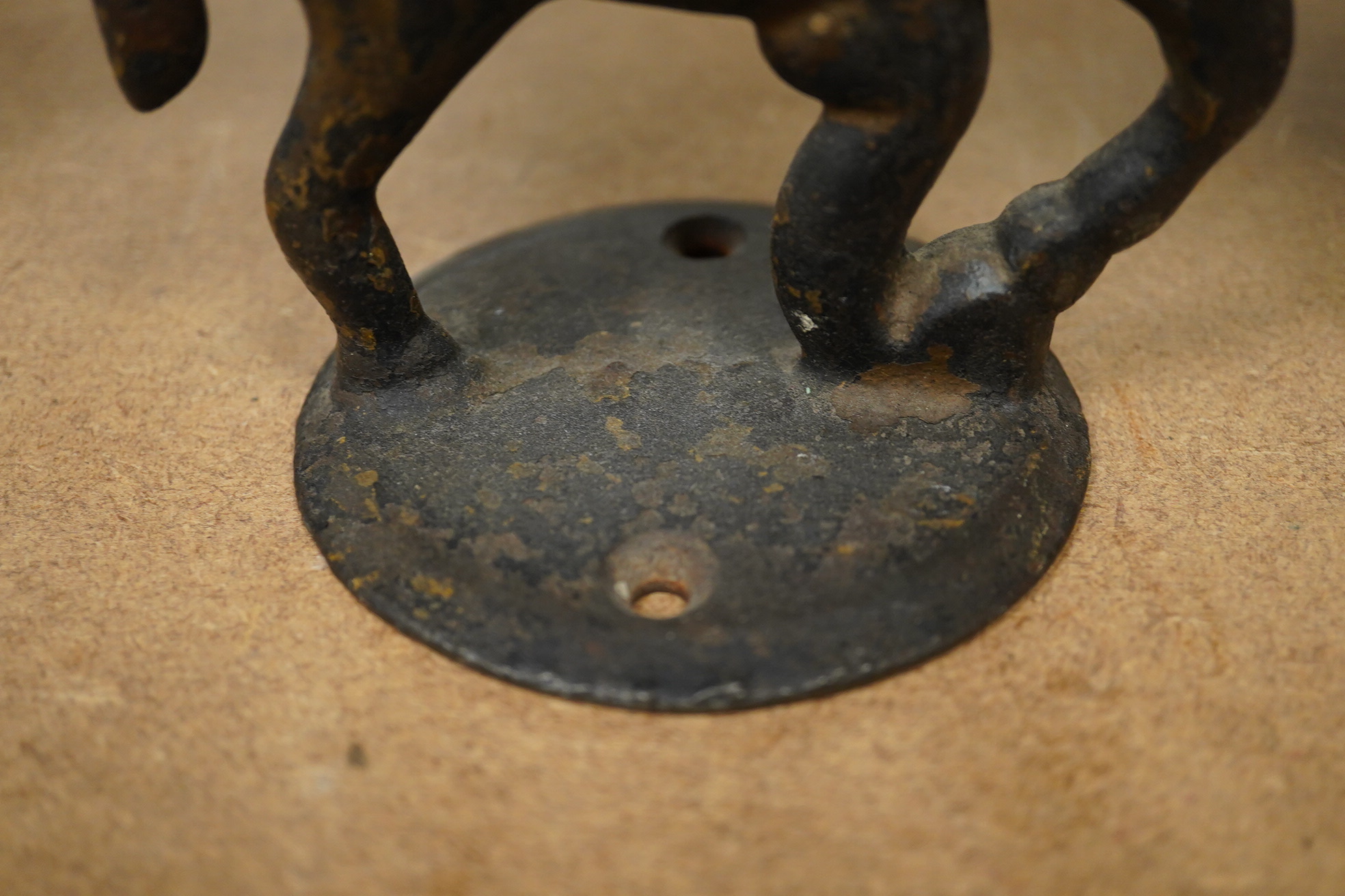 A small pair of novelty iron ‘horse’ boot scrapers. 18cm high. Condition - poor, base mounts missing